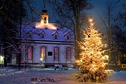 Victorian home at Christmas time with Christmas lights on the outside tree